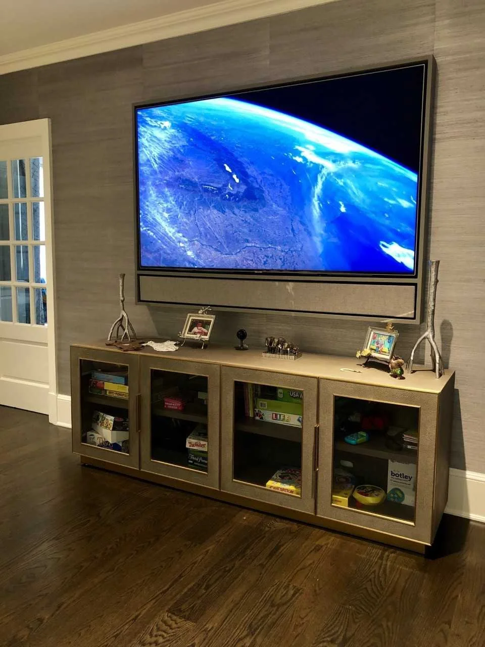 Family Room with a 75" TV hidden inside a custom built Media Decor cabinet made by Leon speakers. The cabinet also includes a built in soundbar.