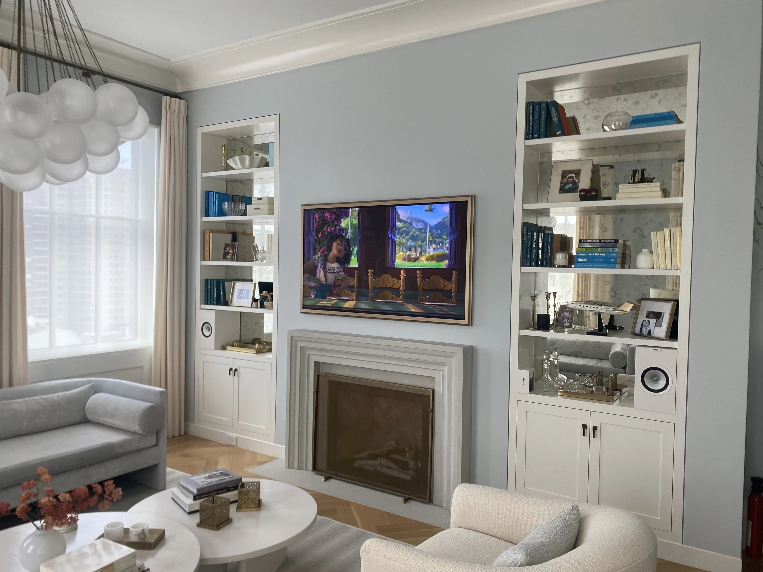 Living room with a Samsung Frame TV and Kef speakers for audio controlled with a Savant control System.