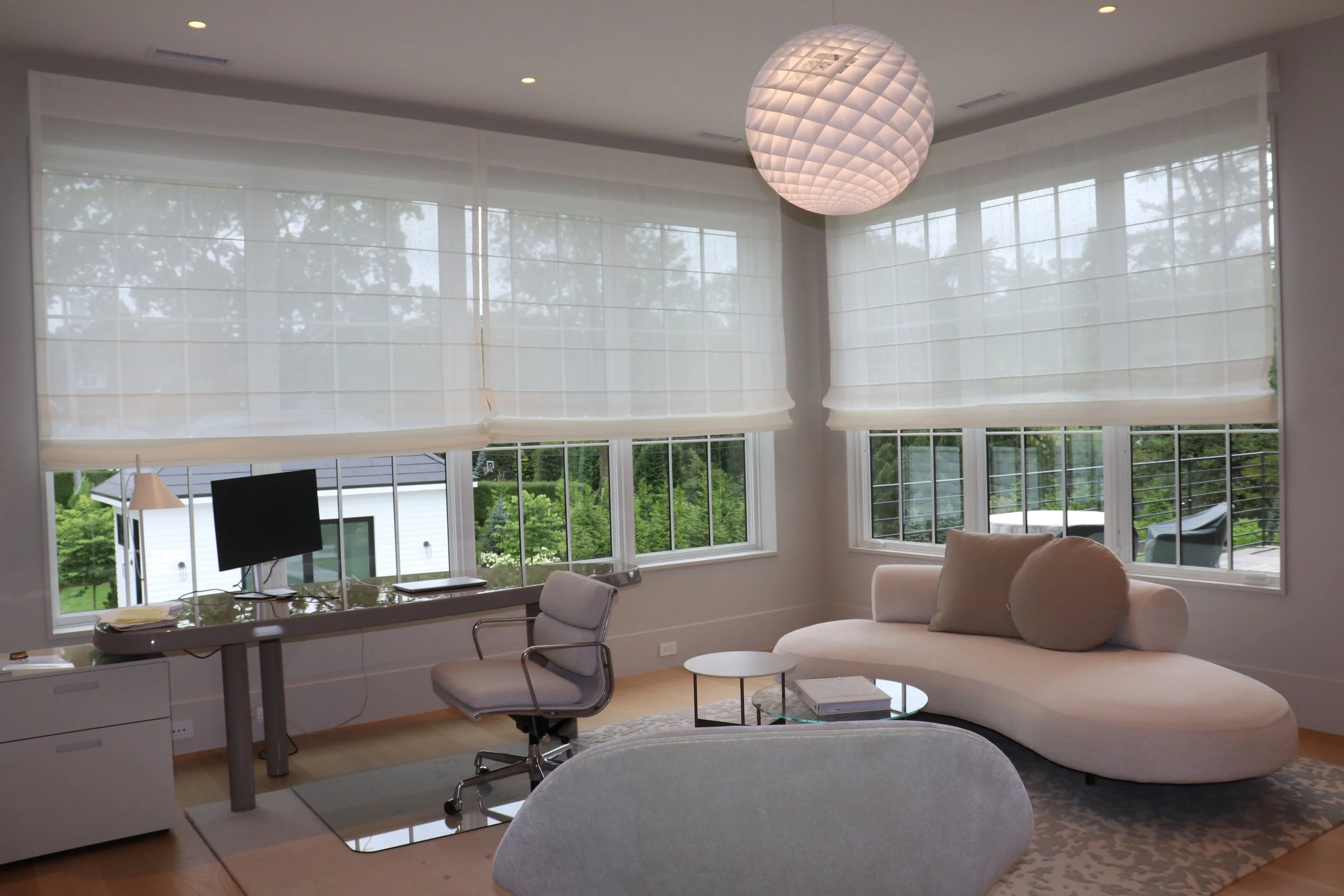 Office with custom built motorized Roman Shades. Lutron HomeWorks QSX and Savant control the shades and the lights in this room