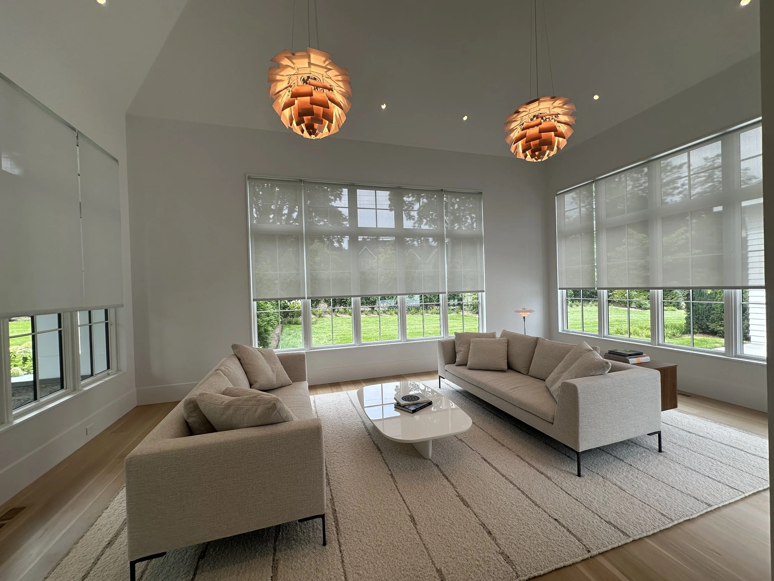 Sunroom with Lutron Palladiom Shades and Louis Poulsen Artichoke Pendants. All lighting and shading is controlled by Lutron HomeWorks QSX and integrated into Savant.