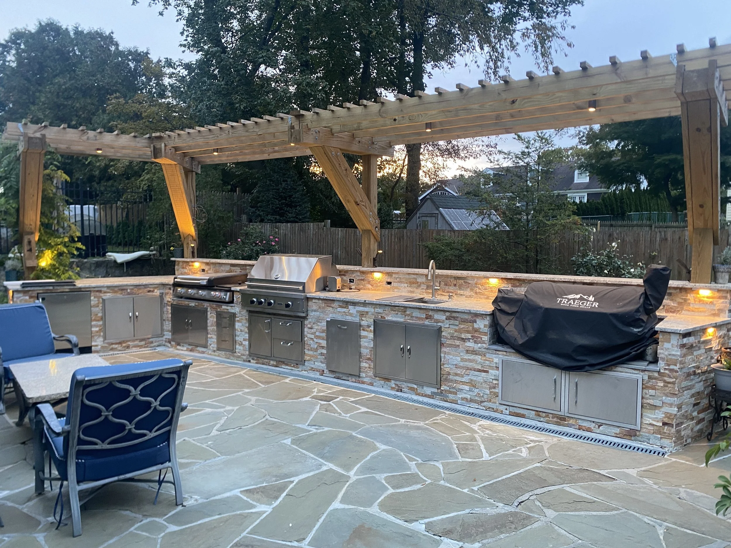 Outdoor Kitchen with accent lighting. All exterior lighting is controlled by a Lutron HomeWorks system and integrated in Savant