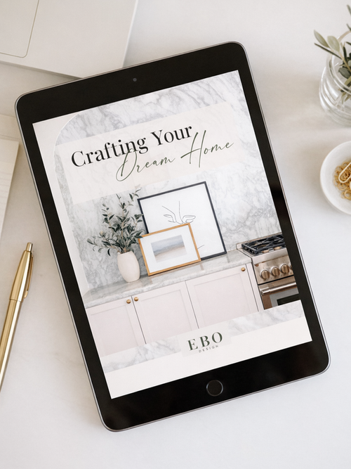 Tablet displaying EBO Design’s “Crafting Your Dream Home” interior design guide, created by an Edmonton-area interior designer, featuring a modern kitchen with marble backsplash and warm neutral finishes.