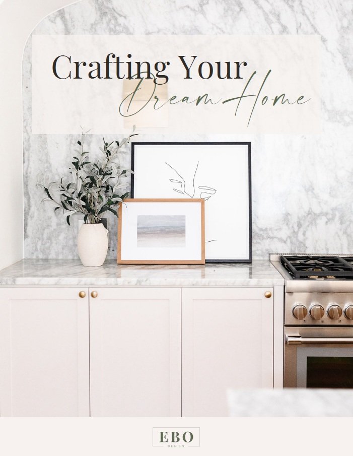 Luxury modern kitchen with marble backsplash, neutral cabinetry, framed artwork, and styled décor by Edmonton interior designer EBO Design.