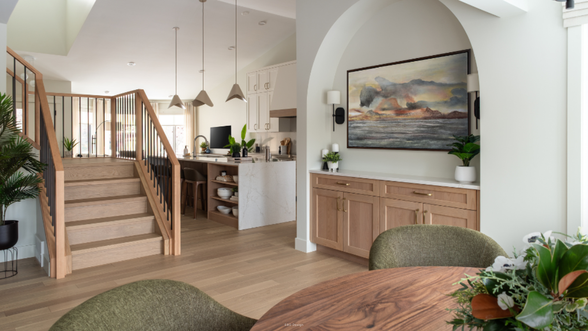 Bright, modern open-concept main floor renovation in Edmonton featuring an arched art niche and custom cabinets.