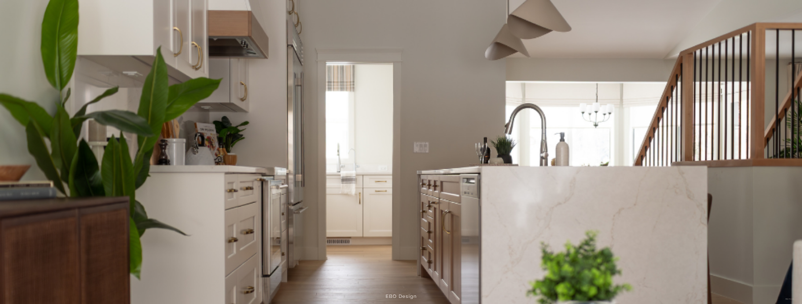 High-end modern kitchen renovation banner showing white cabinetry, custom hood fan, and marble island in Edmonton.