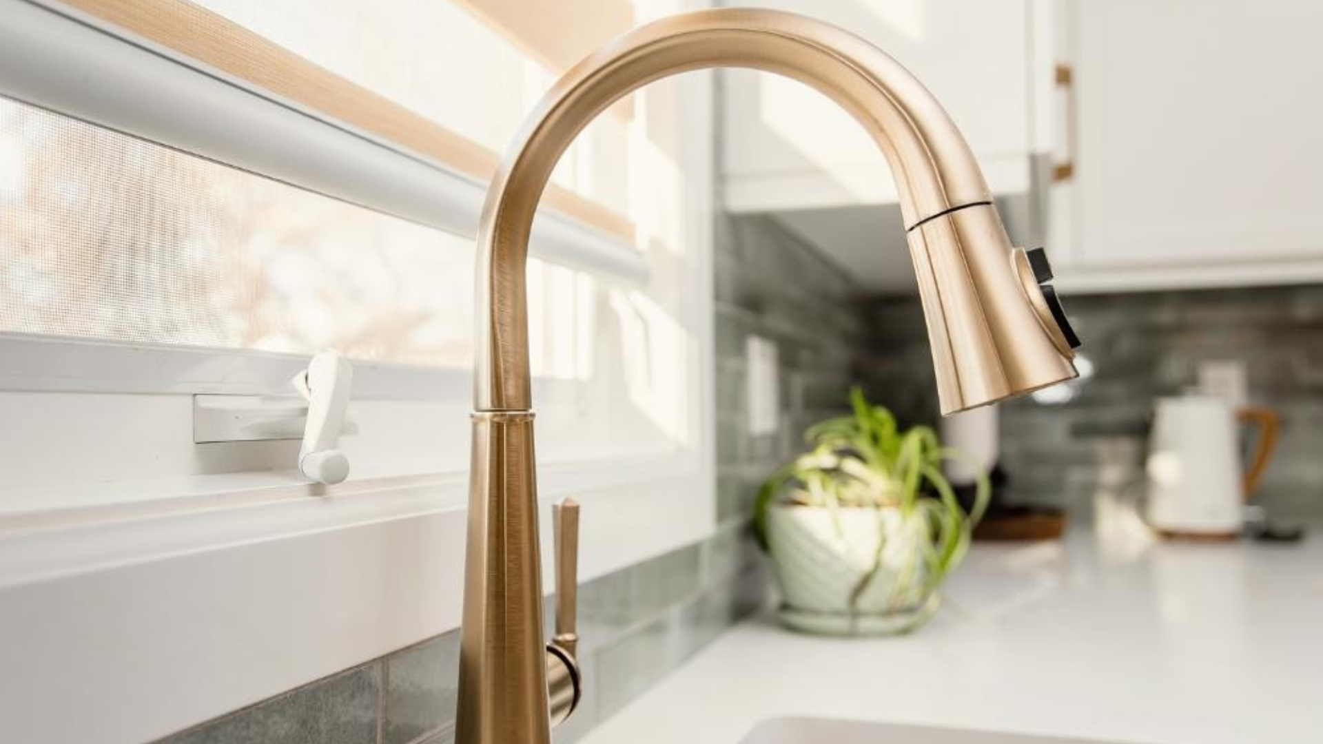 Close-up of a classic brass kitchen faucet showing how thoughtful fixture choices outlast interior design trends.