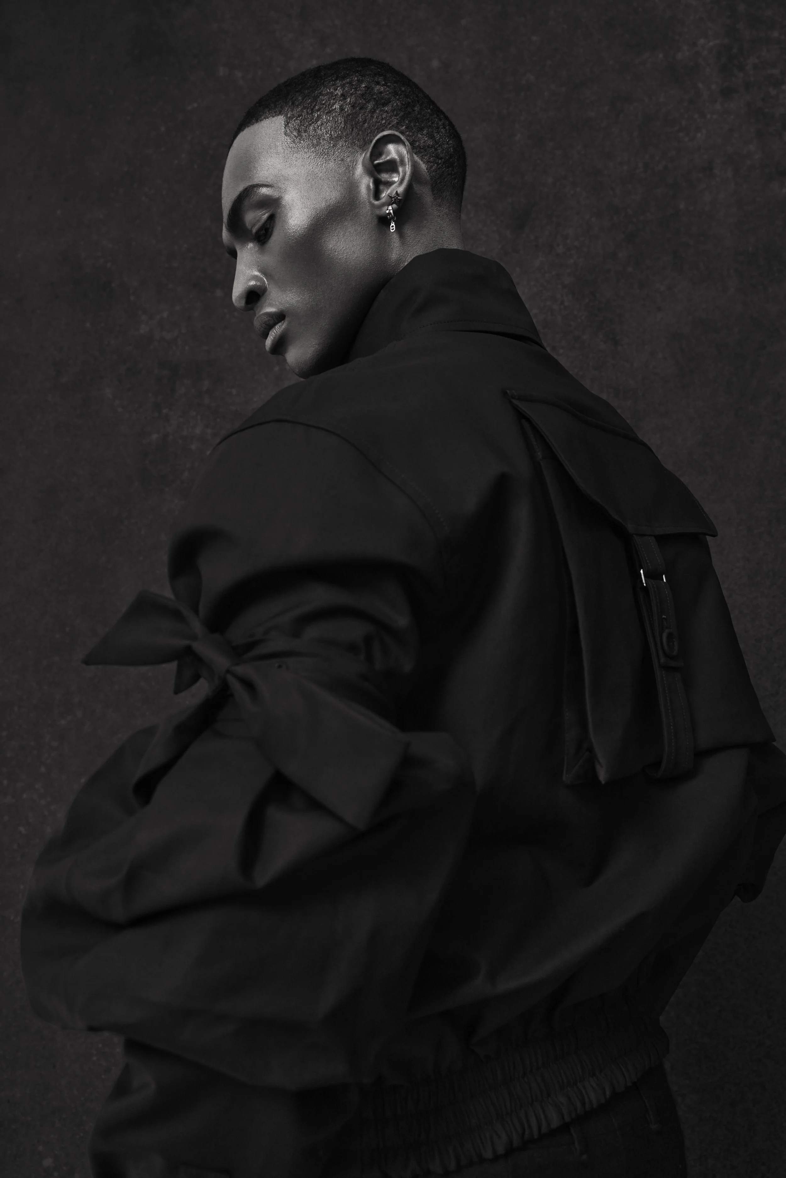 Featured image showing a black hand-painted backdrop rental. The model is posing for a fashion editorial photoshoot for FASHION Canada. 