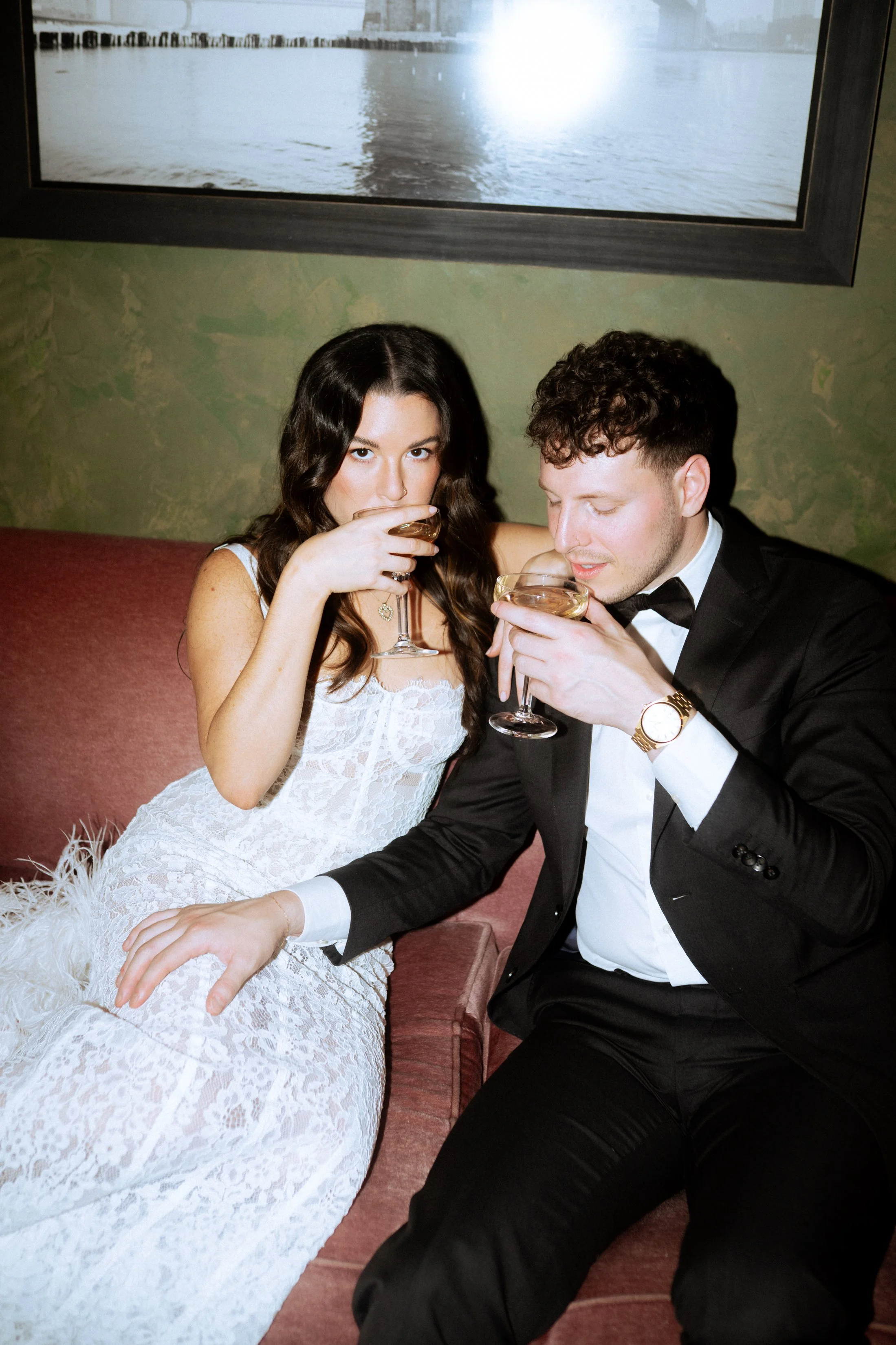 NYC couples portrait photography by Jordan Niccola, NYC engagement at the Beekman Hotel by Hyatt, man in tuxedo, bride in lace dress with champagne