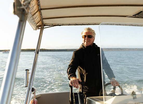 ferry service skipper taking the habour ferry to haulashore island on a cruise at sunset
