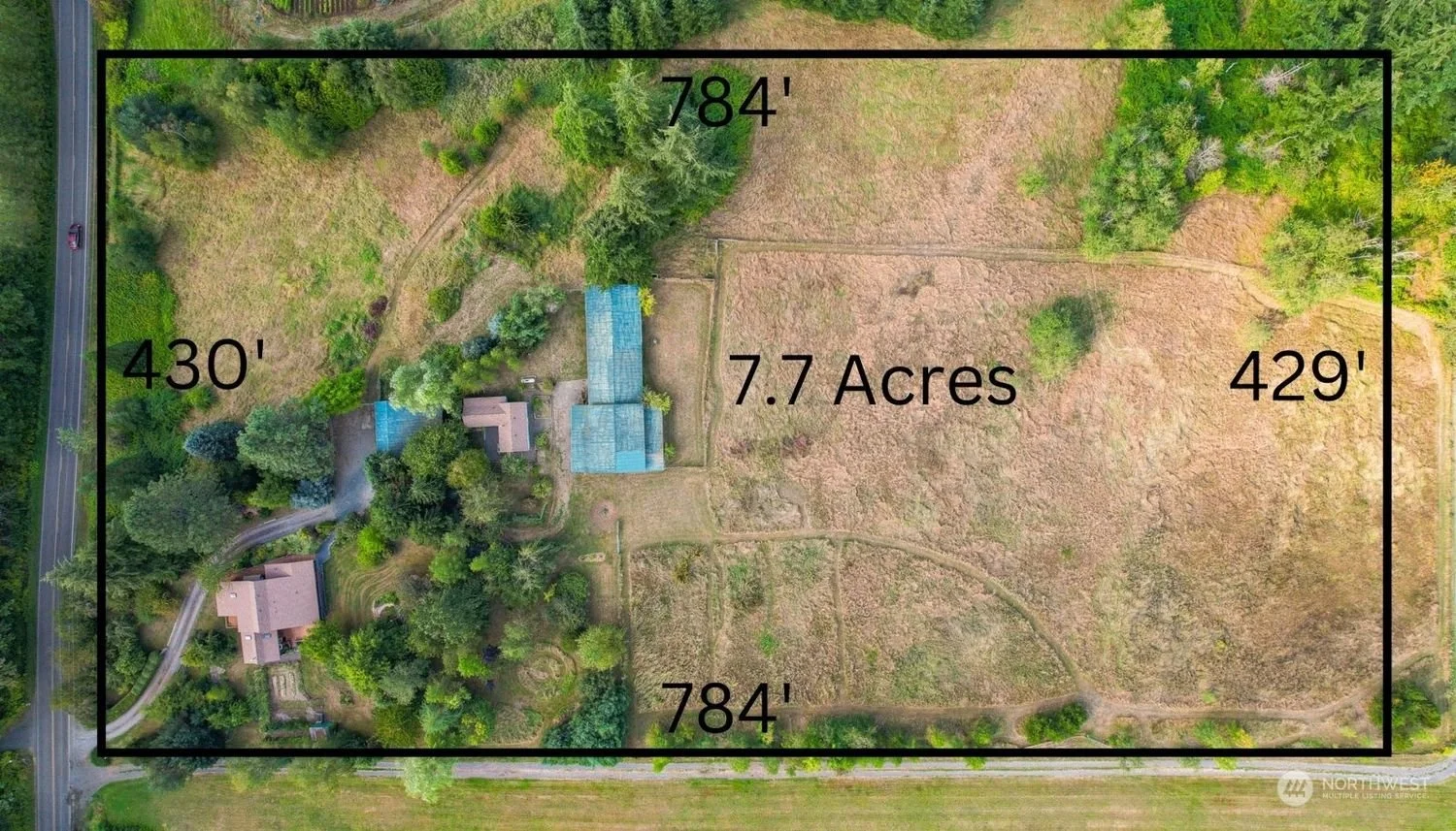 Aerial view of a property with marked boundaries, indicating it is 7.7 acres in size, with dimensions of approximately 784 feet on two sides and 430 and 429 feet on the other sides. The property includes a house, a driveway, trees, and open land.