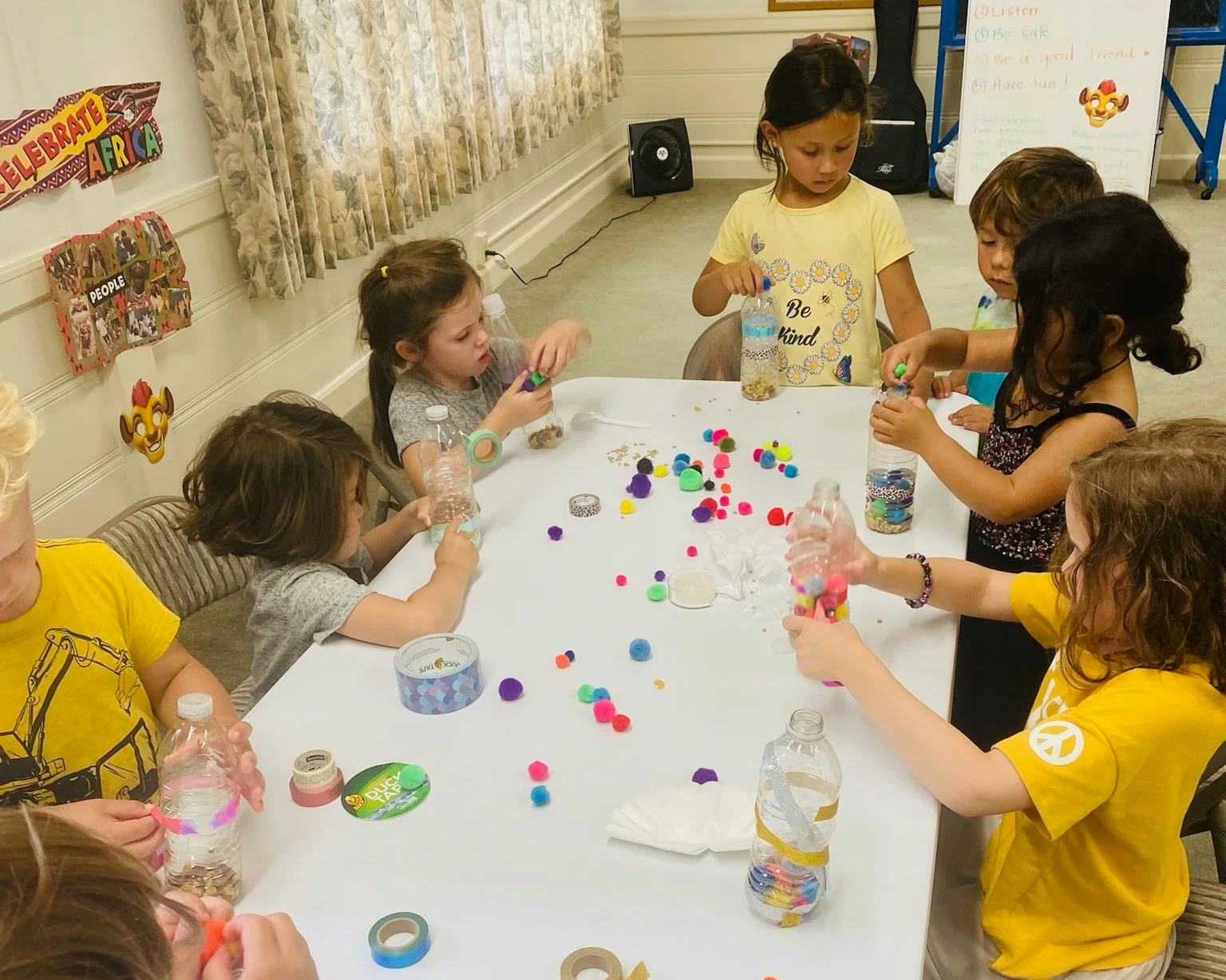 A group of young kids making arts & crafts at Kathy's Music & Movement