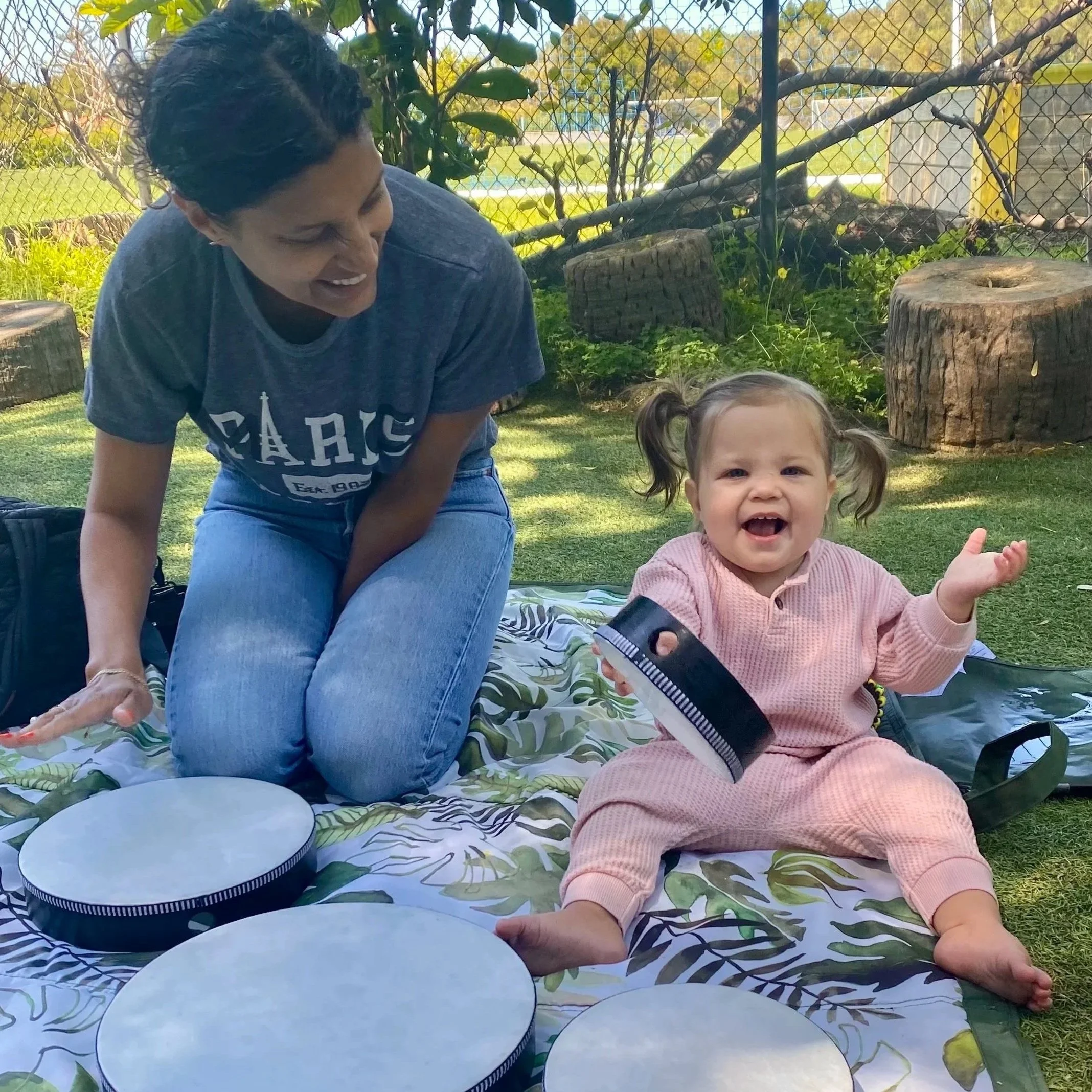 Baby laughing and playing the drums at a music school in Carpinteria Kathys music and movement