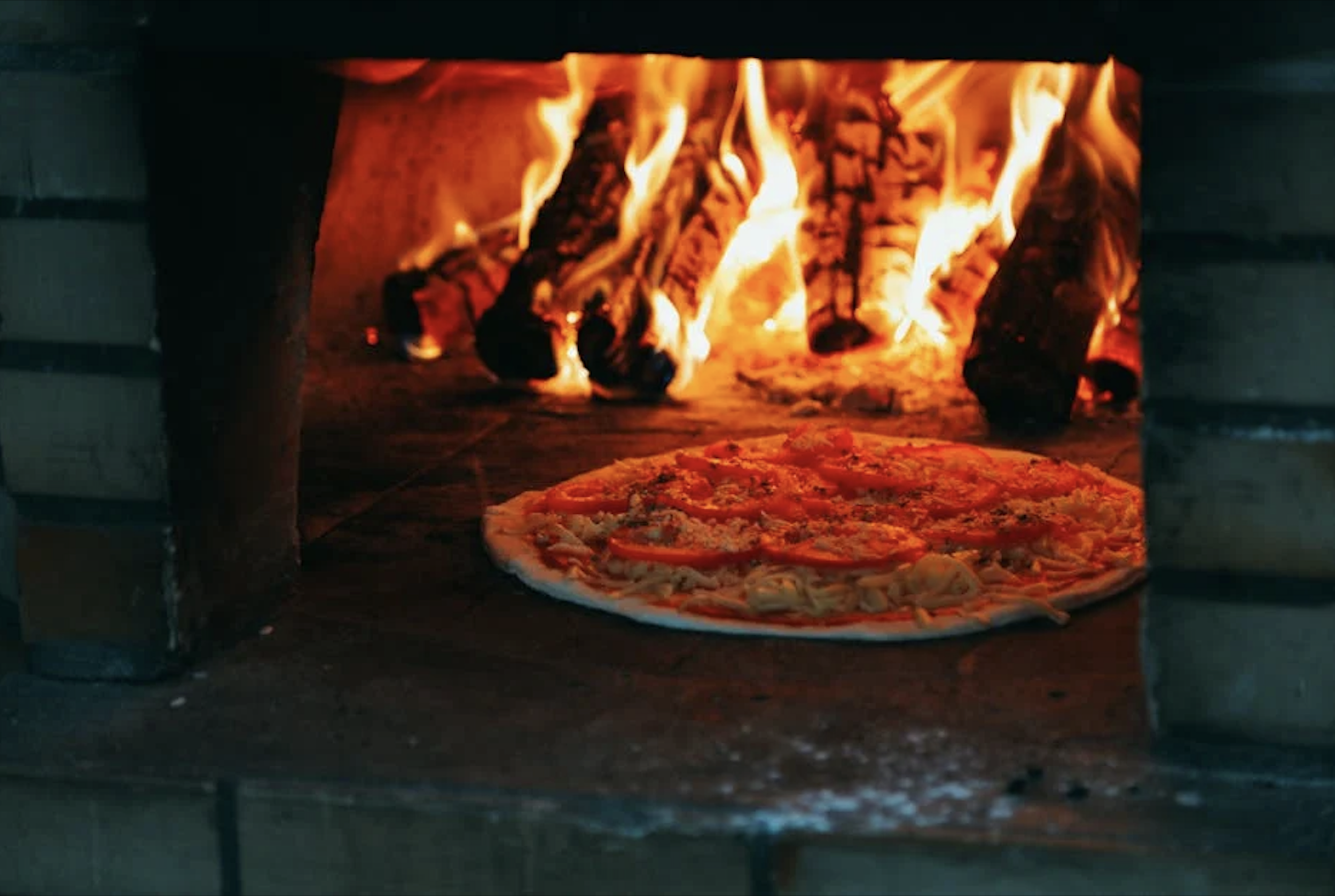 Wood-fired pizza in the oven - brewery with wood fired oven