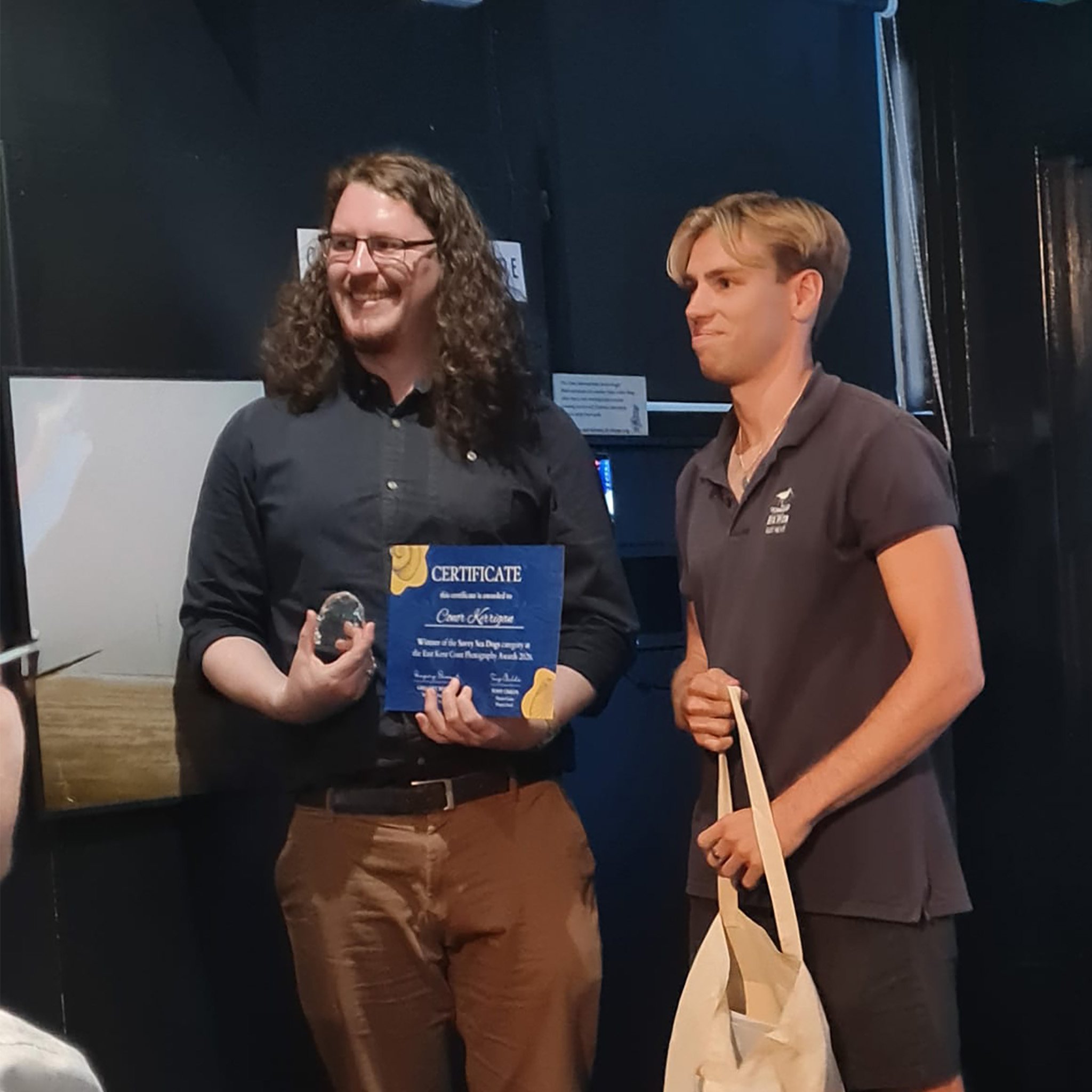 Conor Kerrigan receiving the Savvy Sea Dog photography award.