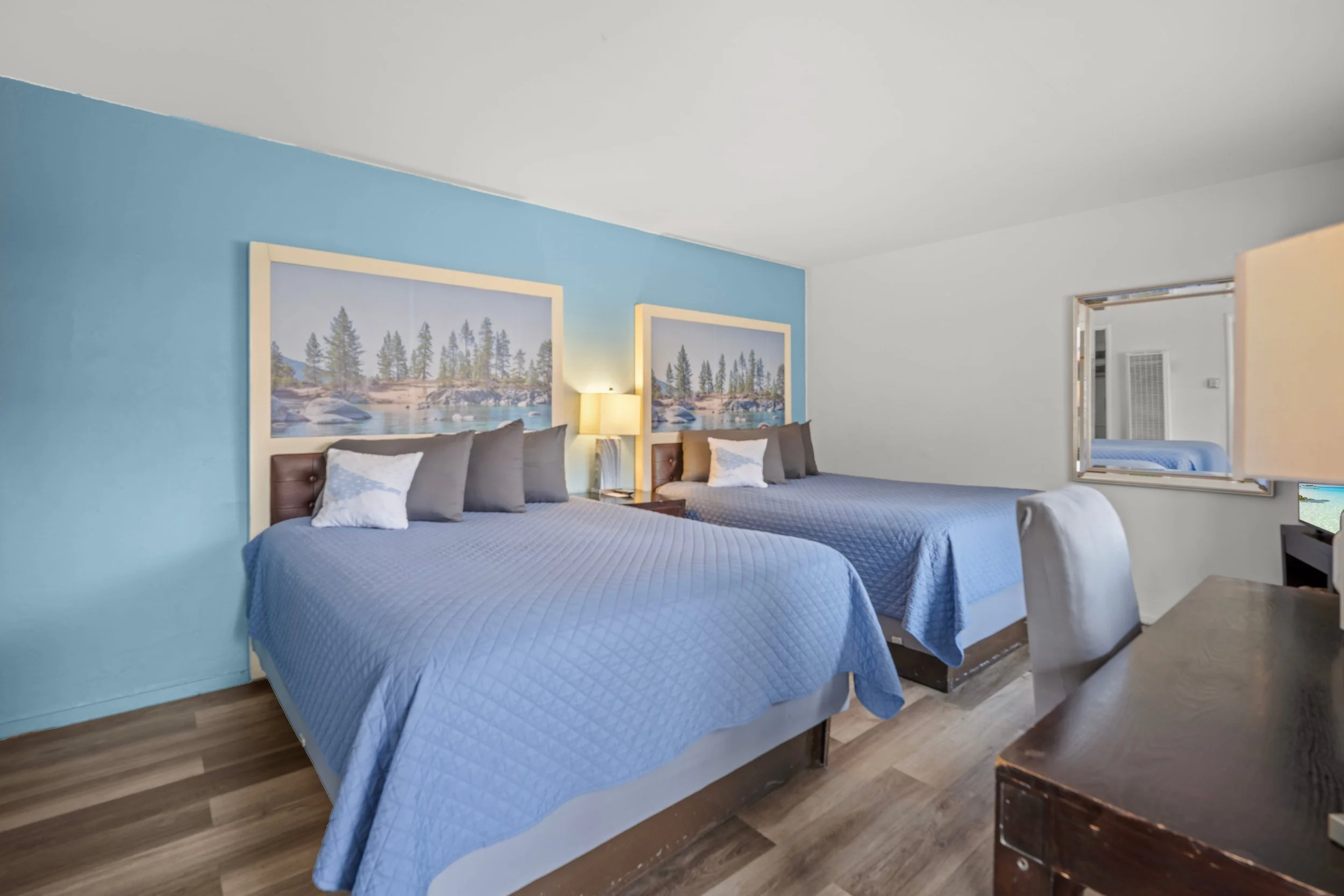 Modern double queen at Bluebird Day Inn & Suites in South Lake Tahoe near Heavenly Mountain Resort with mountain artwork and mini fridge