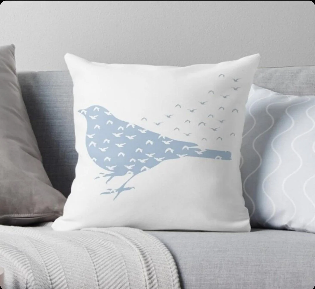 Decorative pillow featuring a bird design with a flock of birds in flight. Comfortable rooms at Bluebird Day Inn.