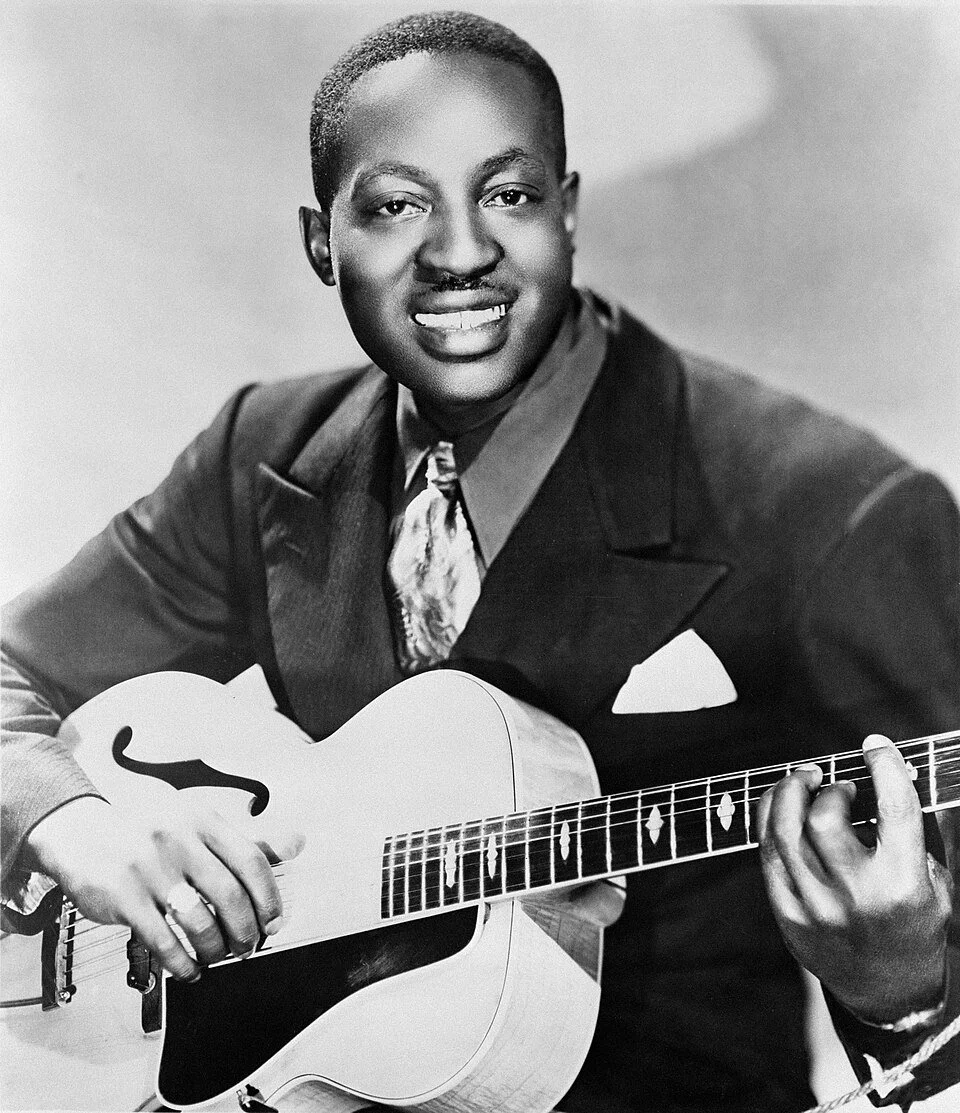 A black and white photograph of Big Bill Broonzy, originally published by Mercury Records