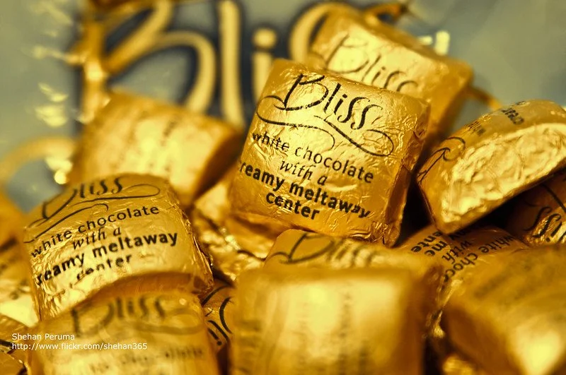 Several pieces of Hershey Bliss chocolate, all in gold wrappings