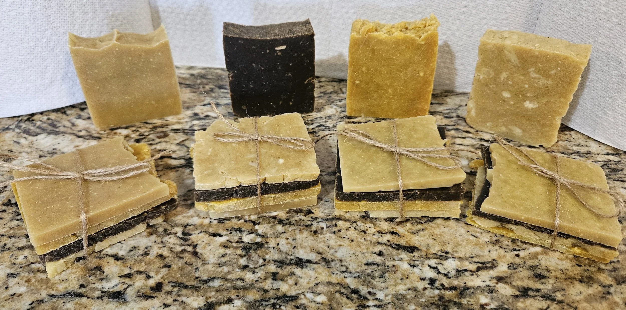 Soap bars and soap samples on stone surface