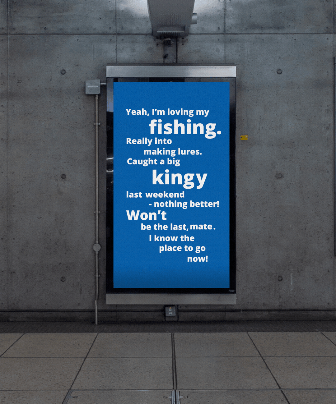 Blue poster for The Mens Table with white text about fishing and catching a big king last weekend, displayed on a wall in an indoor public space.