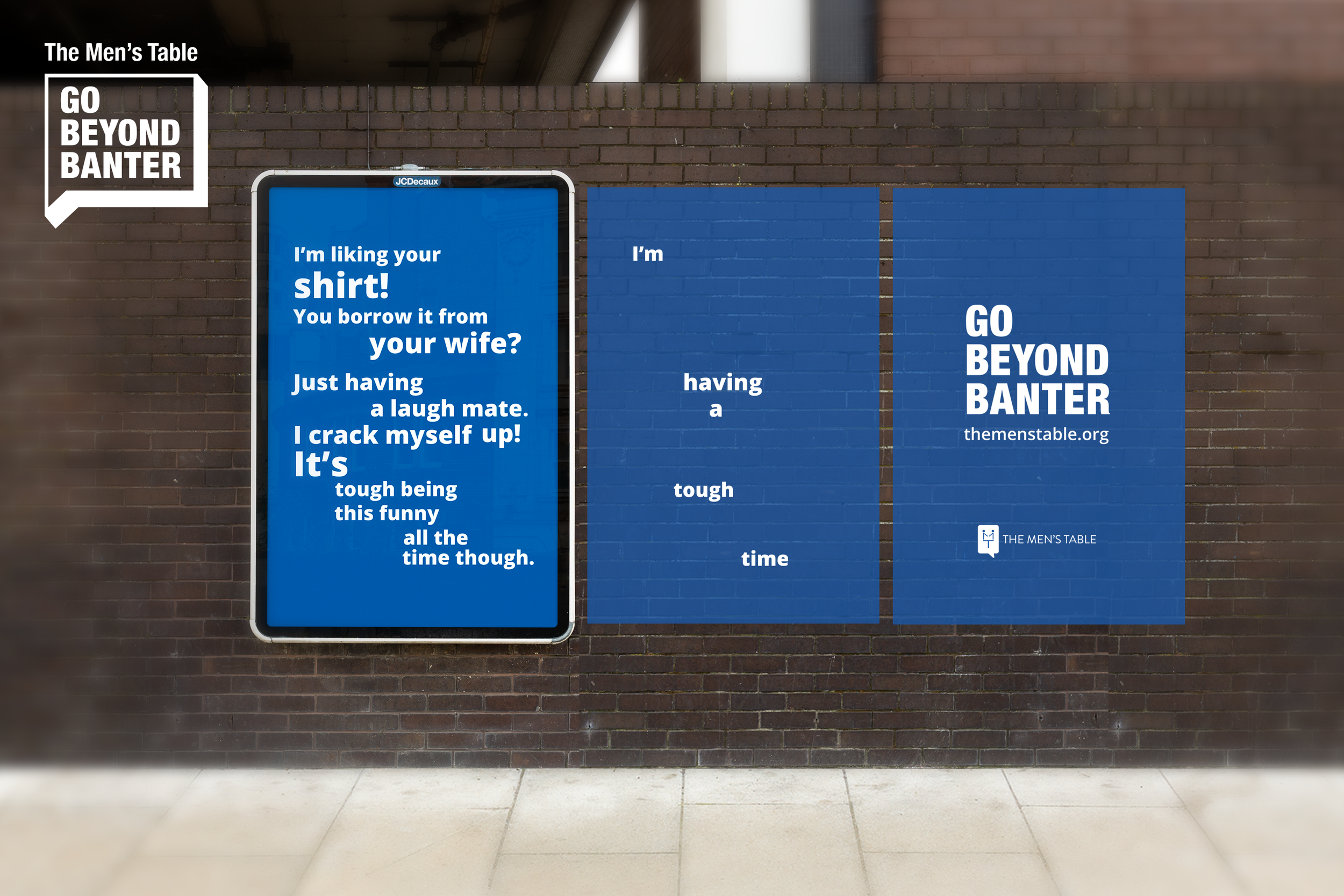 Digital advert for The Mens Table on a brick wall featuring a humorous dialogue about shirts, with a slogan 'Go Beyond Banter' and website 'themenstable.org'.