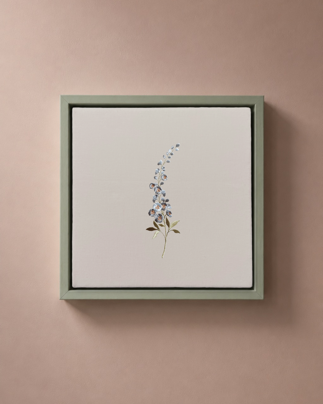 Larkspur July birth flower canvas featuring botanical embroidery in a sage green frame.