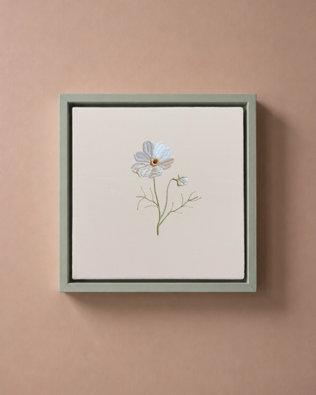 Cosmos October birth flower canvas featuring botanical embroidery in a sage green frame.