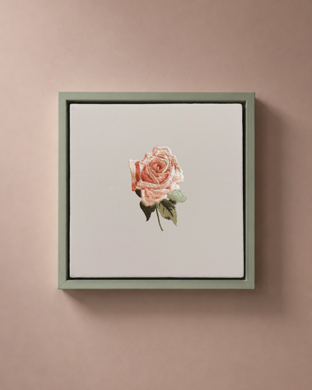 Rose June birth flower canvas featuring botanical embroidery in a sage green frame.