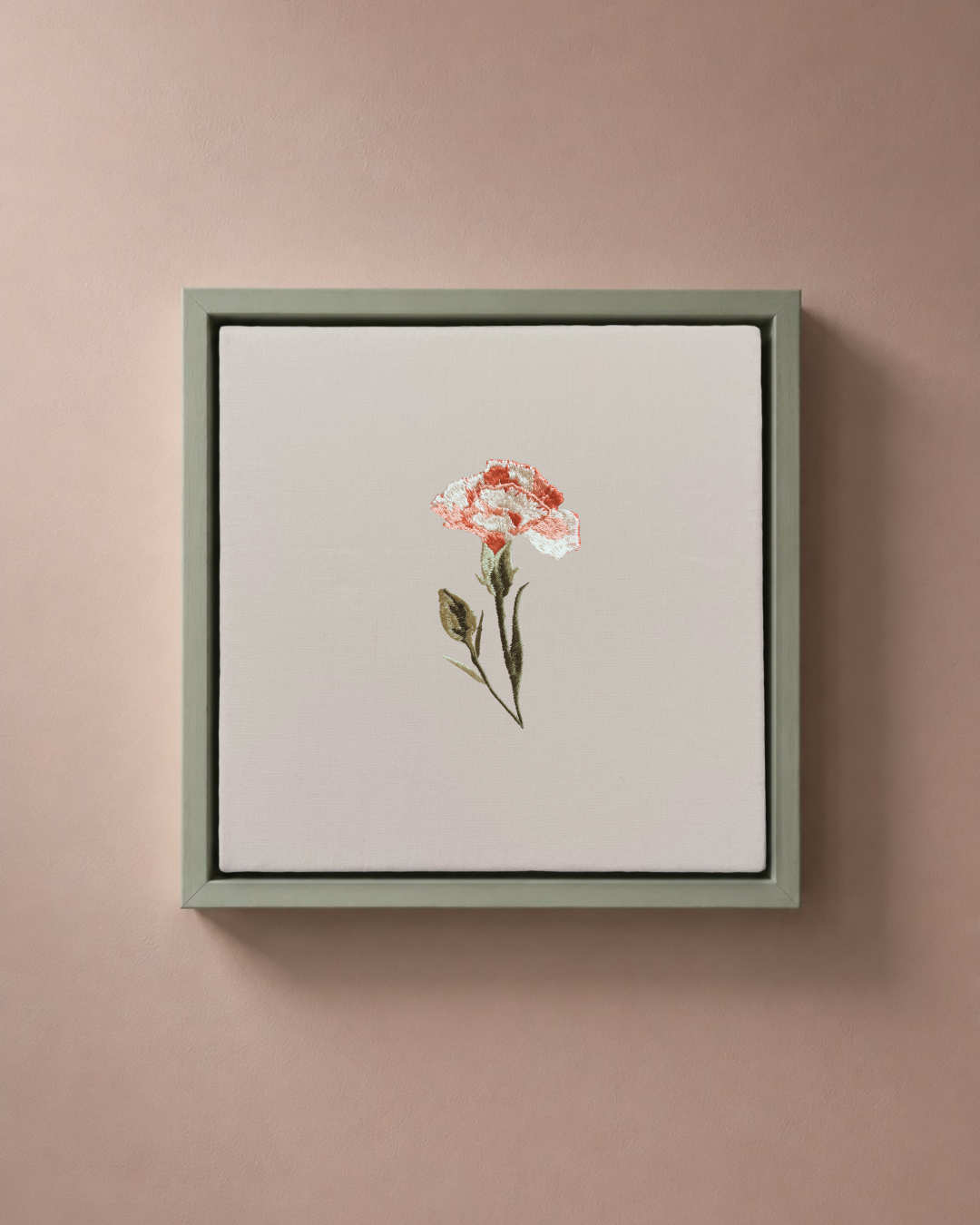 Carnation January birth flower canvas featuring botanical embroidery in a sage green frame.