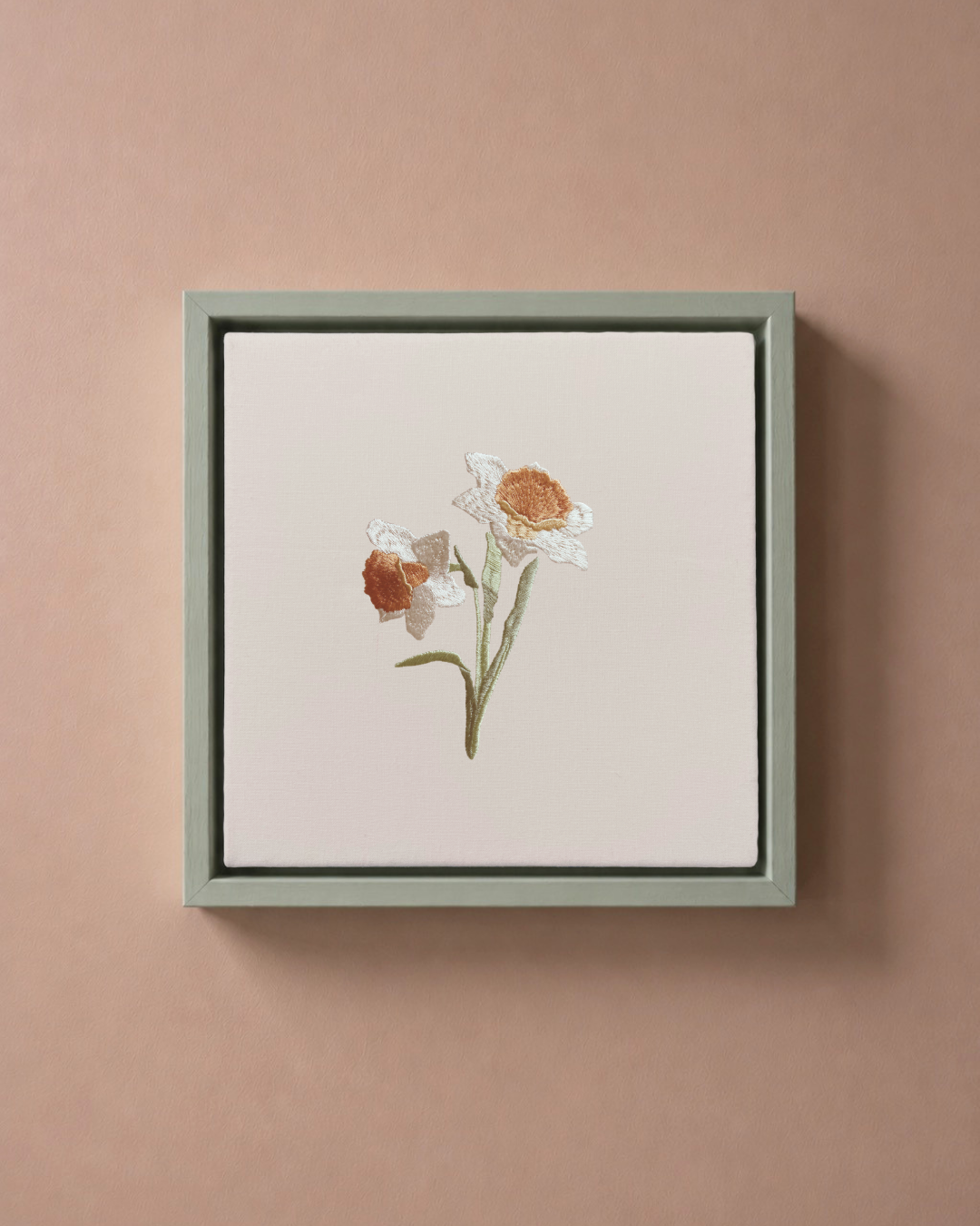Daffodil March birth flower canvas featuring botanical embroidery in a sage green frame.