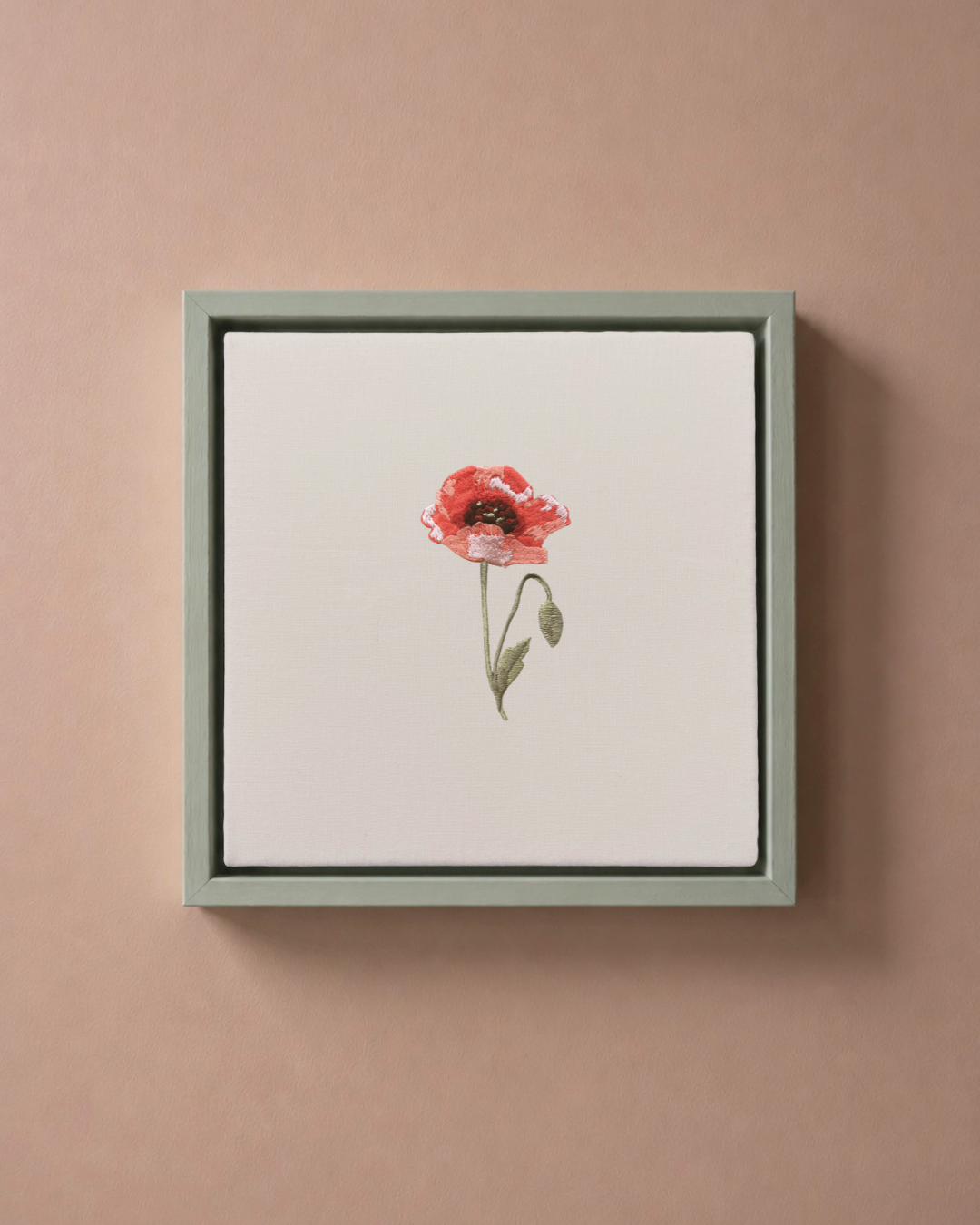 Poppy August birth flower canvas featuring botanical embroidery in a sage green frame.