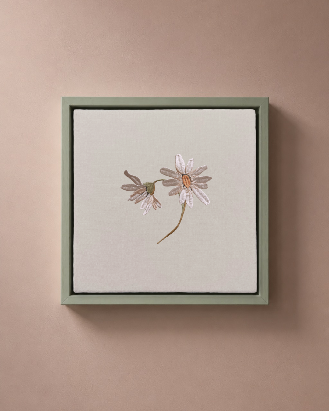 Daisy April birth flower canvas featuring botanical embroidery in a sage green frame.