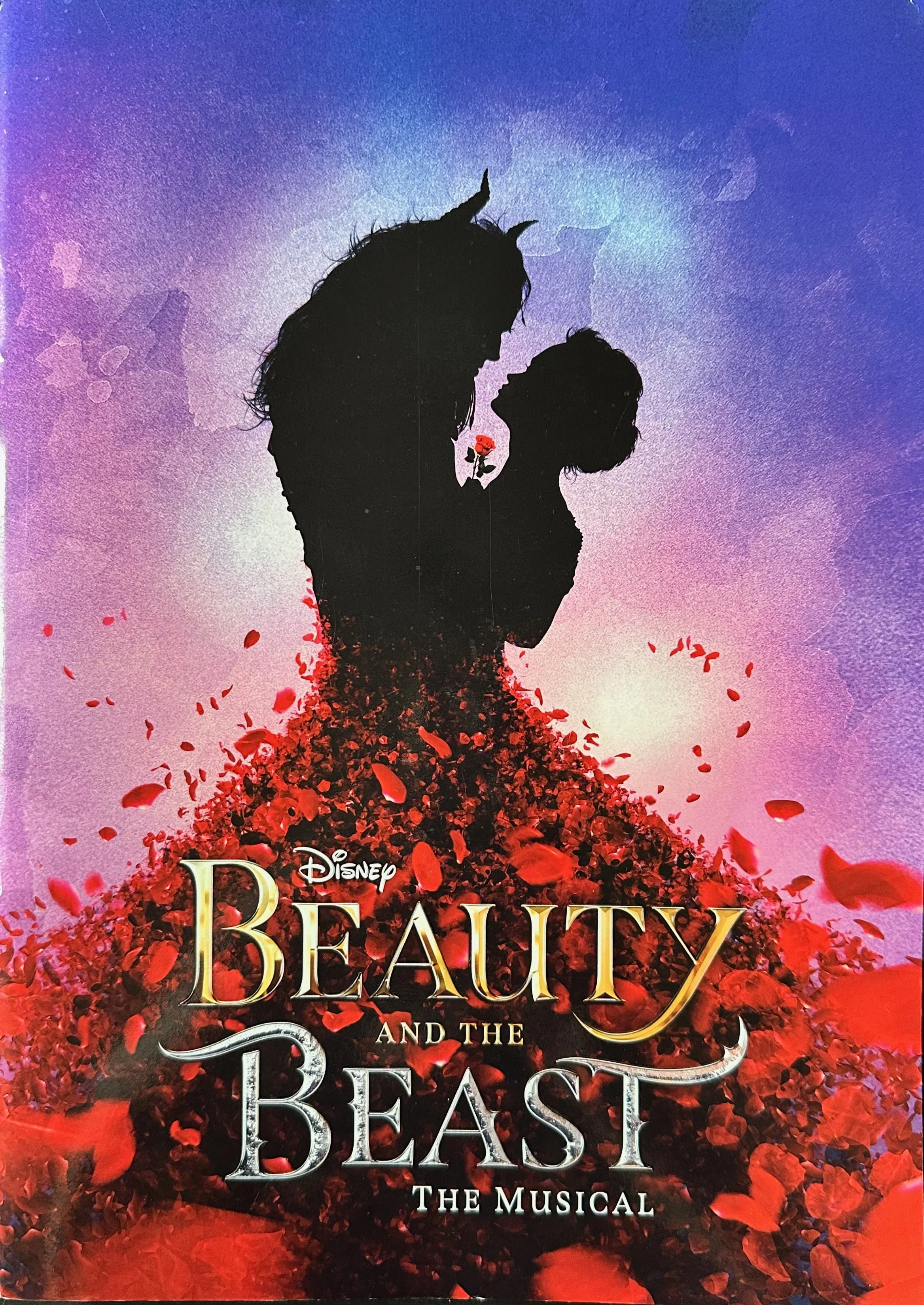 Poster for Disney's Beauty and the Beast musical. Silhouette of a woman and a beastly figure facing each other, surrounded by red petals with a purple and pink background.