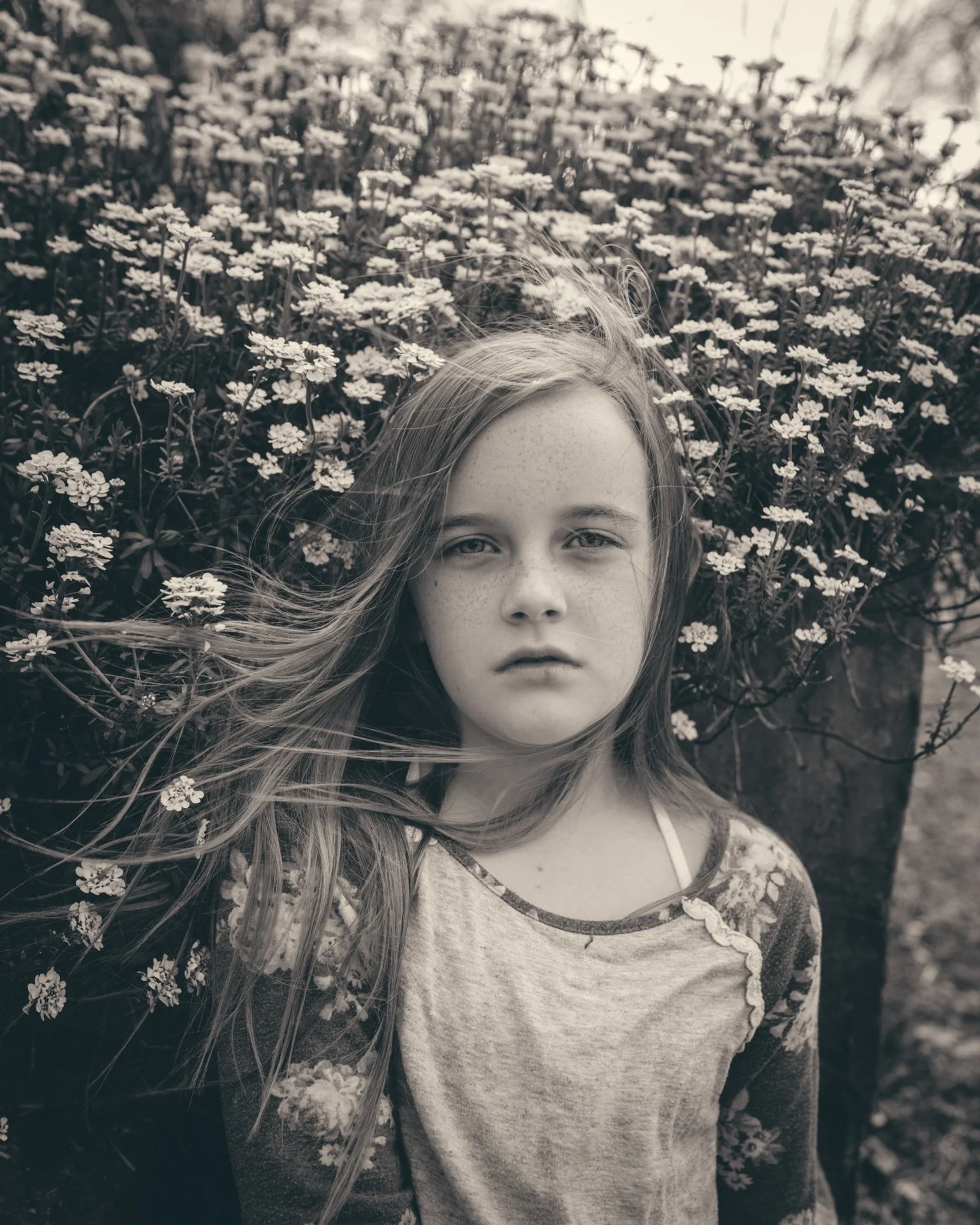 Portrait of a girl in front of spring flowers in Asheville