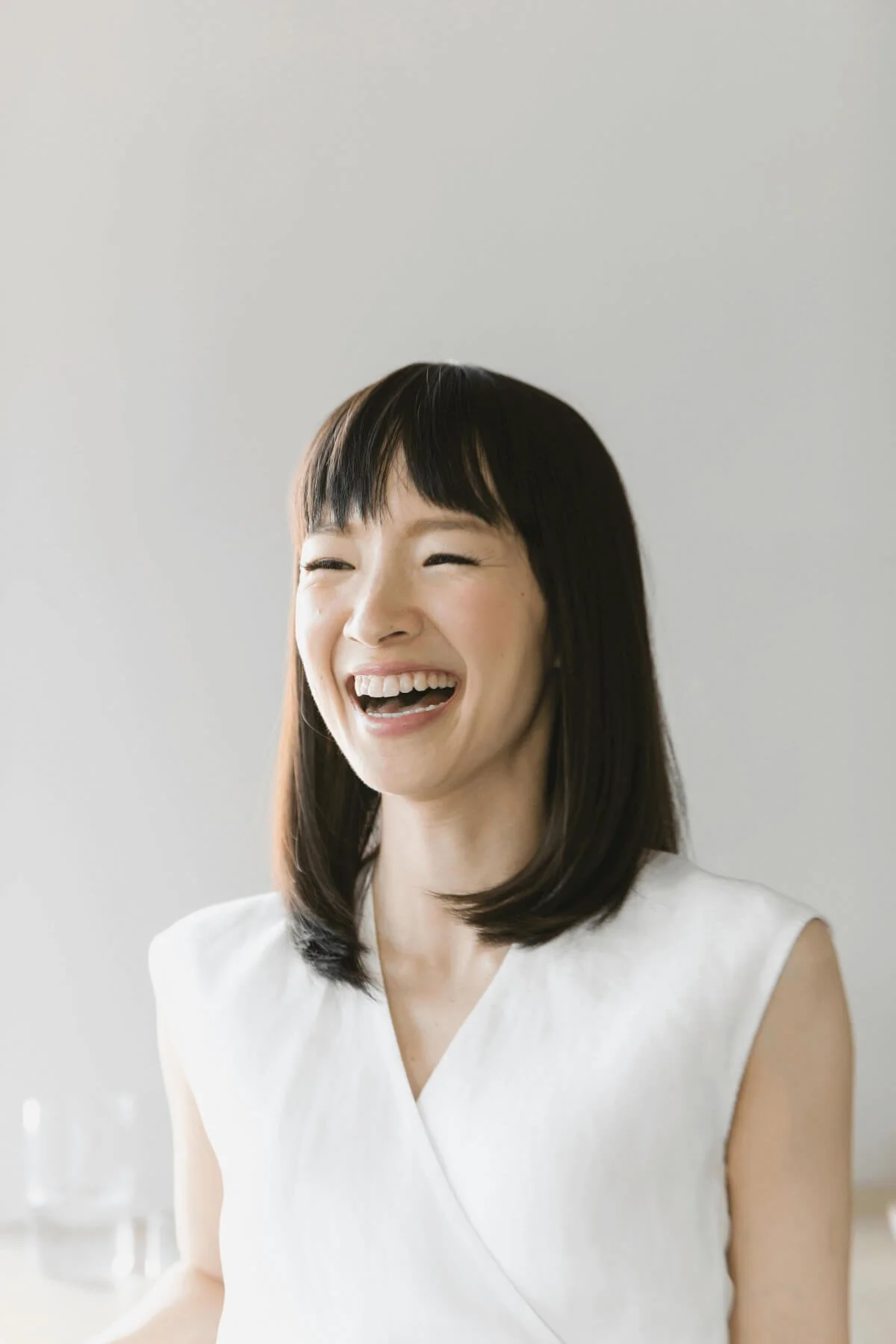 Marie Kondo laughing.