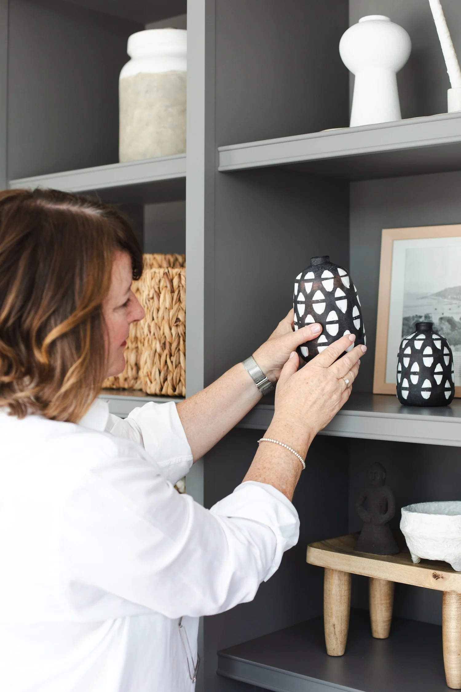 Heather Martin arranging an ornament on a shelf