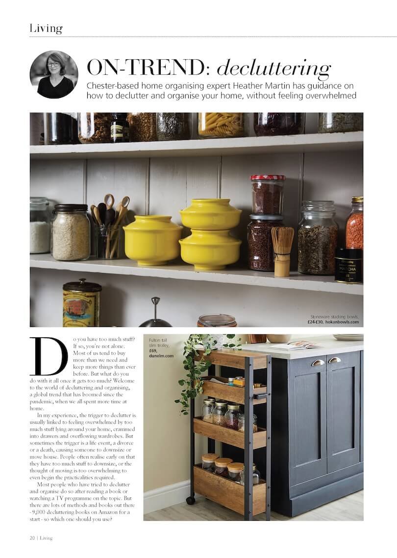 A magazine page featuring home organization tips. The top image shows kitchen shelves with various glass jars and stoneware bowls. The bottom image depicts a black cabinet with a wooden rolling cart holding jars, next to a decorative potted plant.
