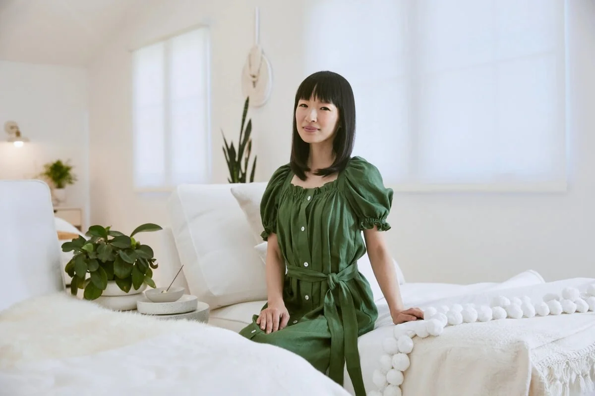 Marie Kondo smiling wearing a brown shirt.