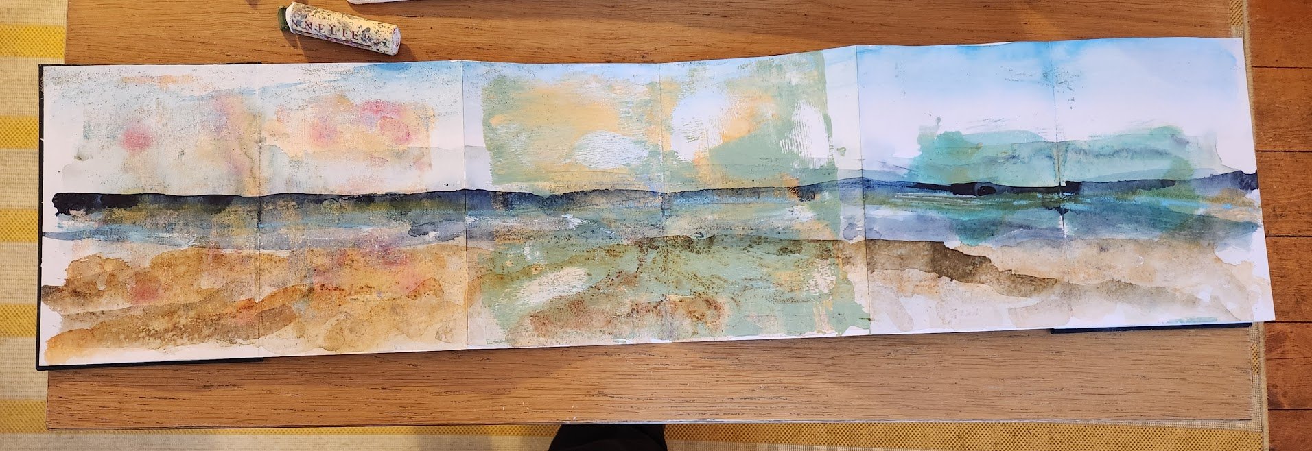 A panoramic watercolor painting of a landscape, possibly a seascape, with a horizon line, blue sky, green and brown land or water, and reflections on the water's surface.