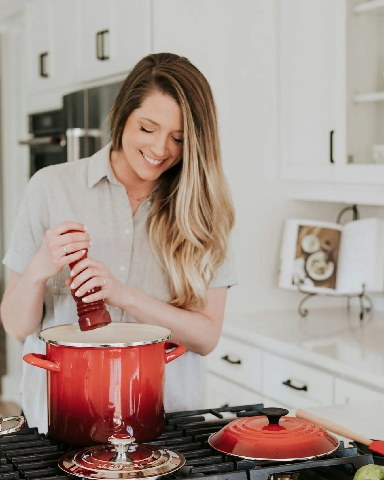 Woman at stove with pepper mill