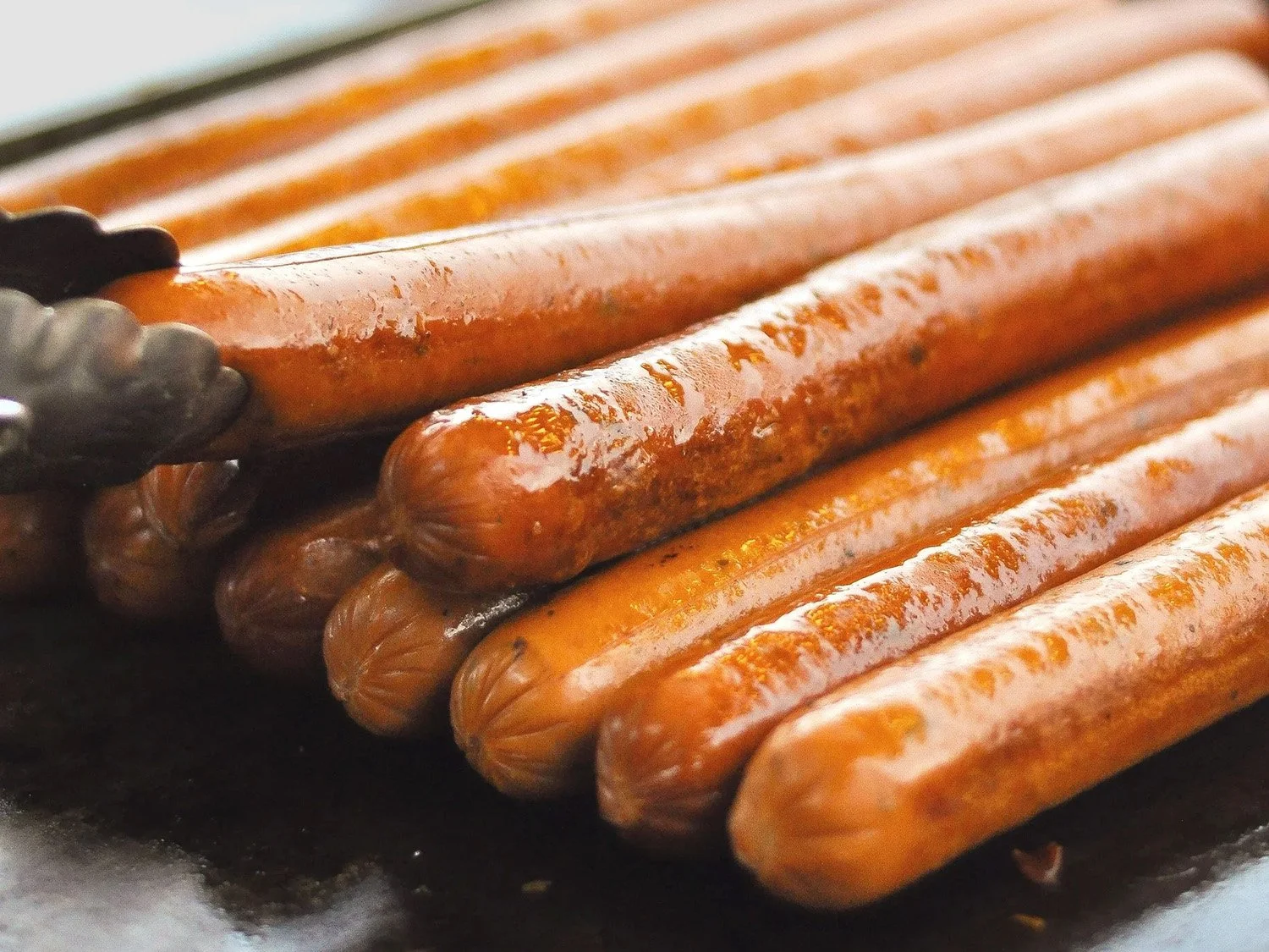 grilled hot dogs on a hot pan