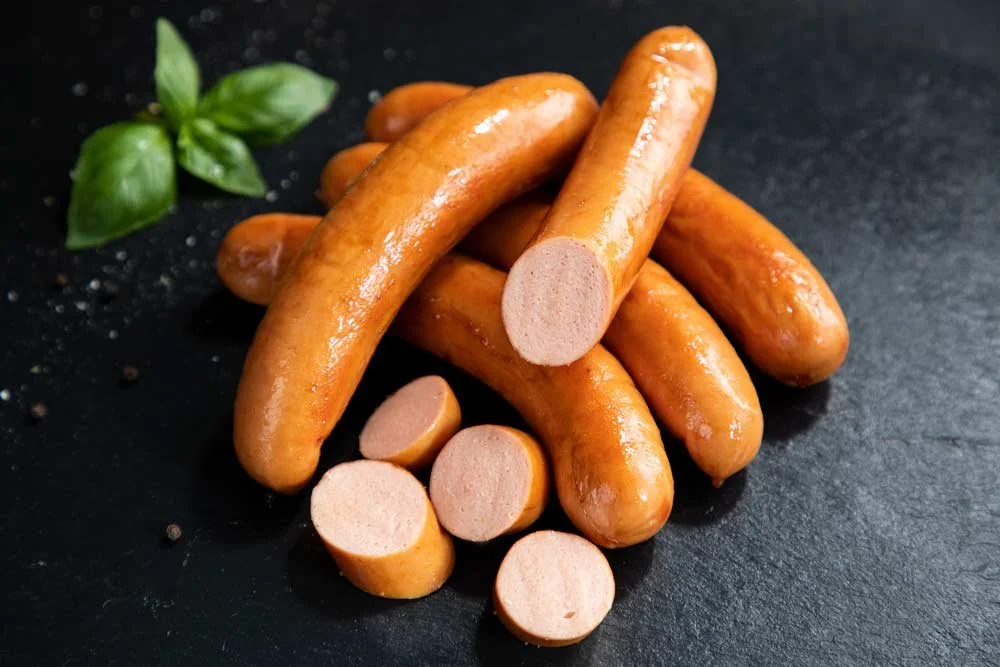 sliced frankfurters on a black slate