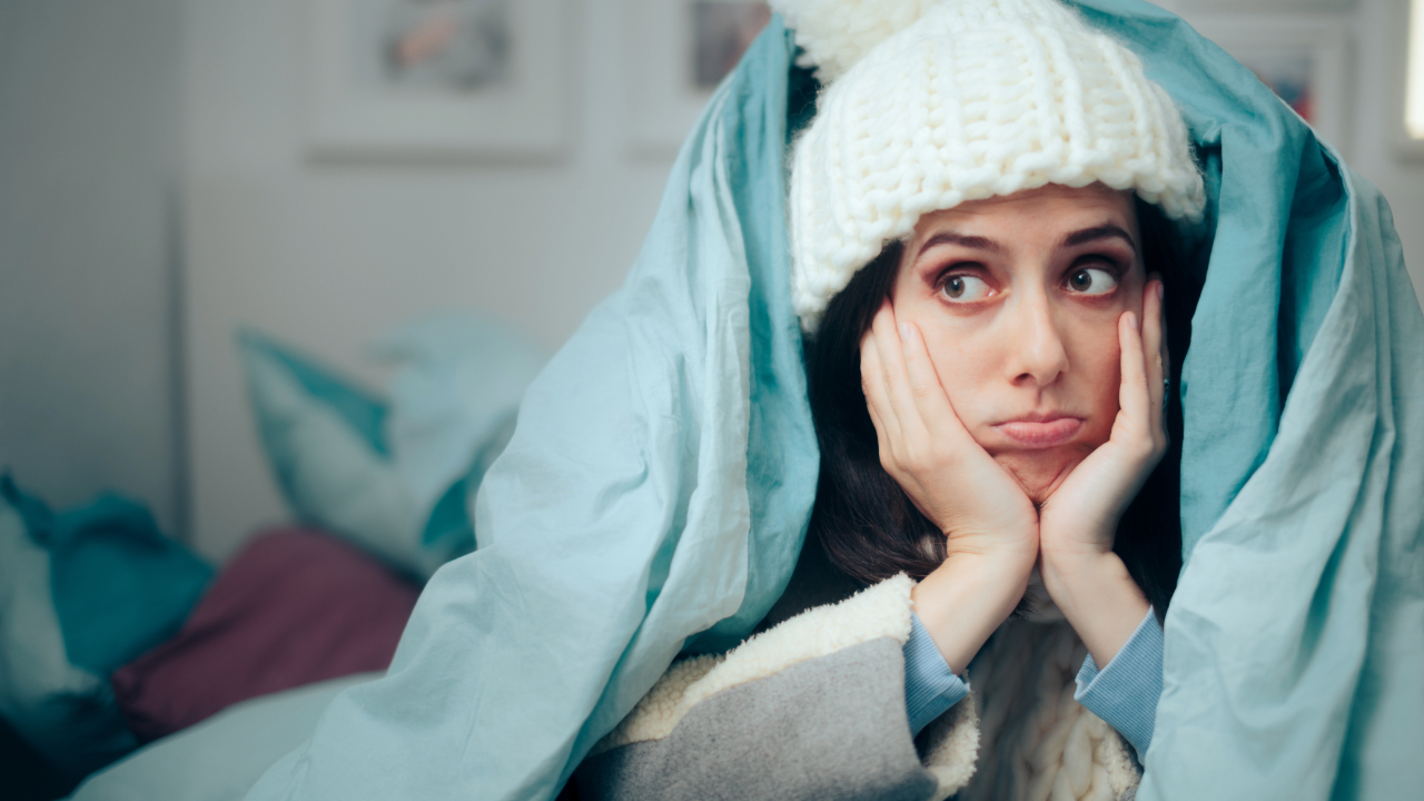 Adobe Stock - cold person under blankets