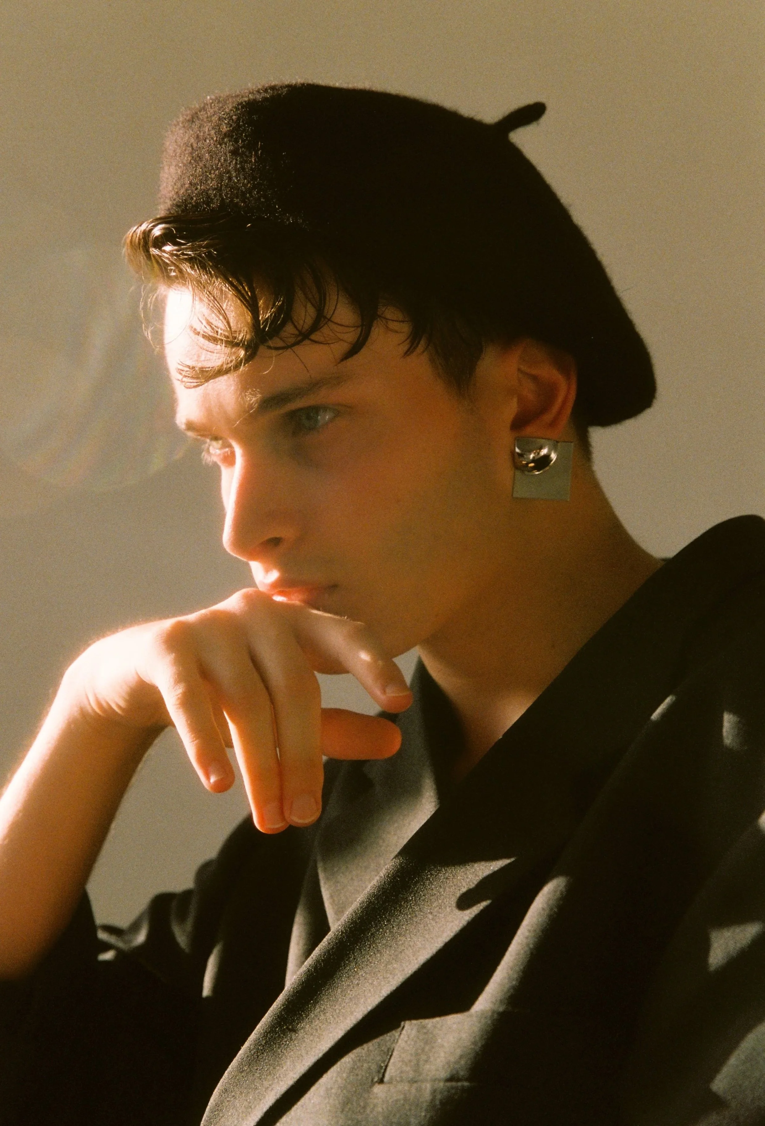 man dressed in a black blazer and black hat