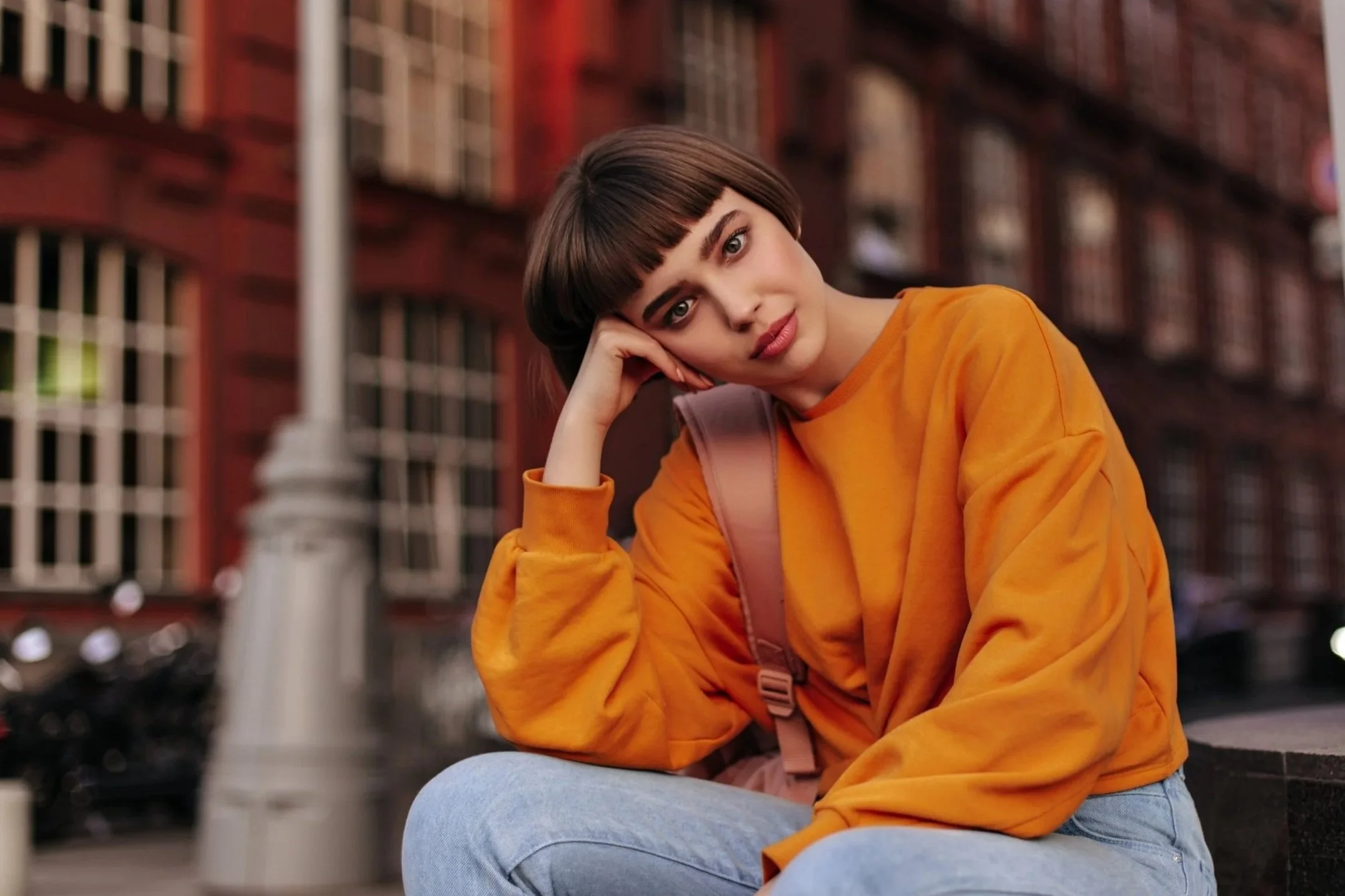 woman in an orange sweatshirt