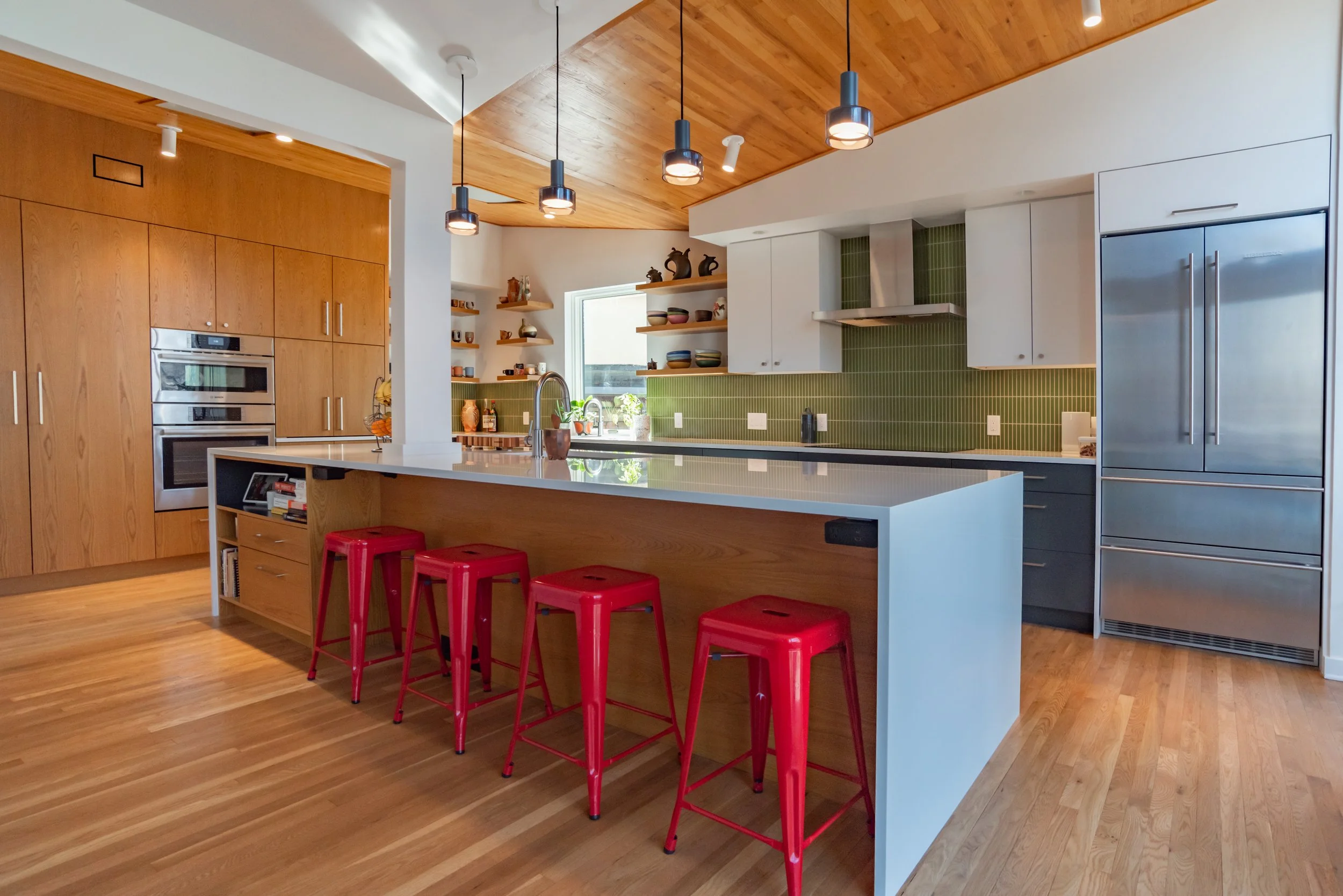 Award winning design and construction for build a home in Pittsburgh with EngineHouse and Moss Architecture featuring a new kitchen, patio slider, natural light quarts countertops and green backsplash