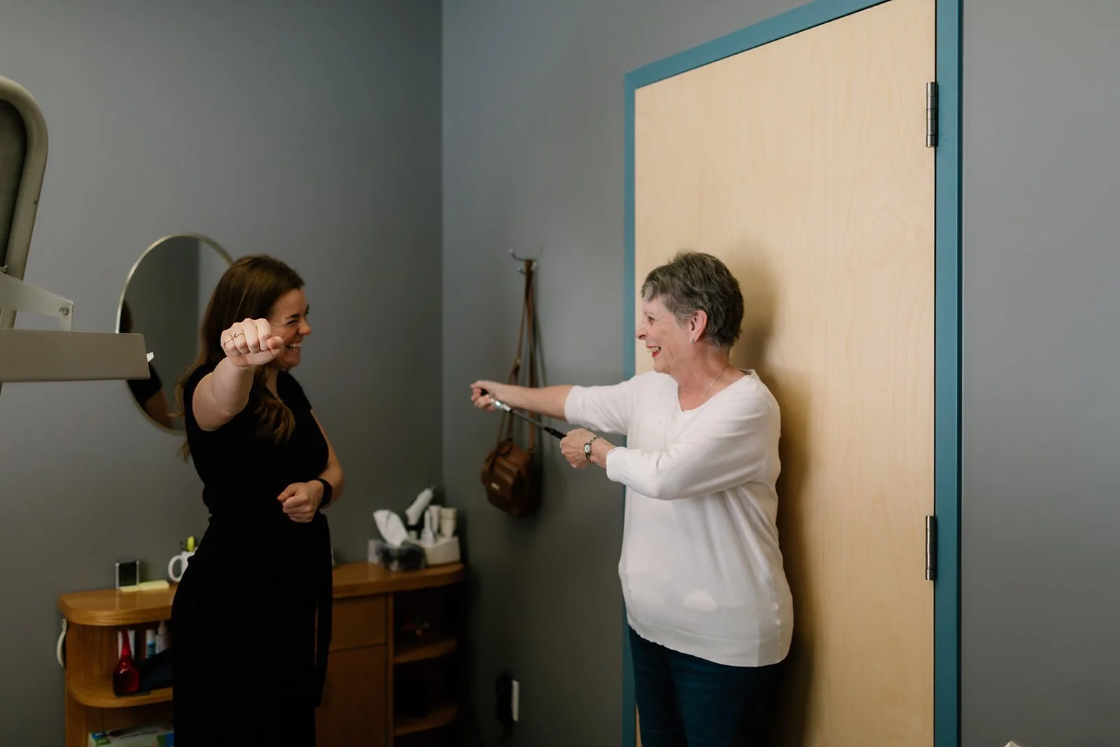 A woman being shown mobility exercises at Hubbel & Johnston Chiropractic