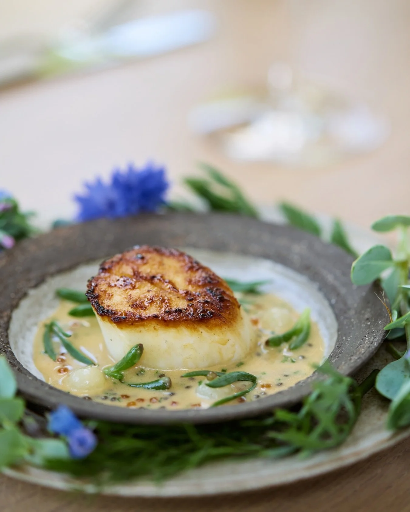 Emma has been patiently grown galangal in the glasshouse this season &mdash; a slow-growing tropical root.

We pair it with thai basil and lemongrass to build a nam jim for our Orkney scallop. 🦪

Image by @oliviabphoto 

#FIFTYTWO #RuddingPark