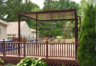 A brown free-standing cover that is covering a section of a deck.