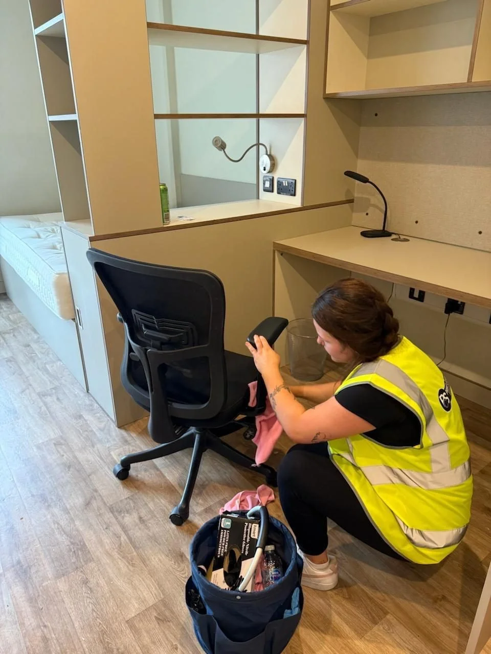 Commercial cleaner cleaning a student accommodation bedroom